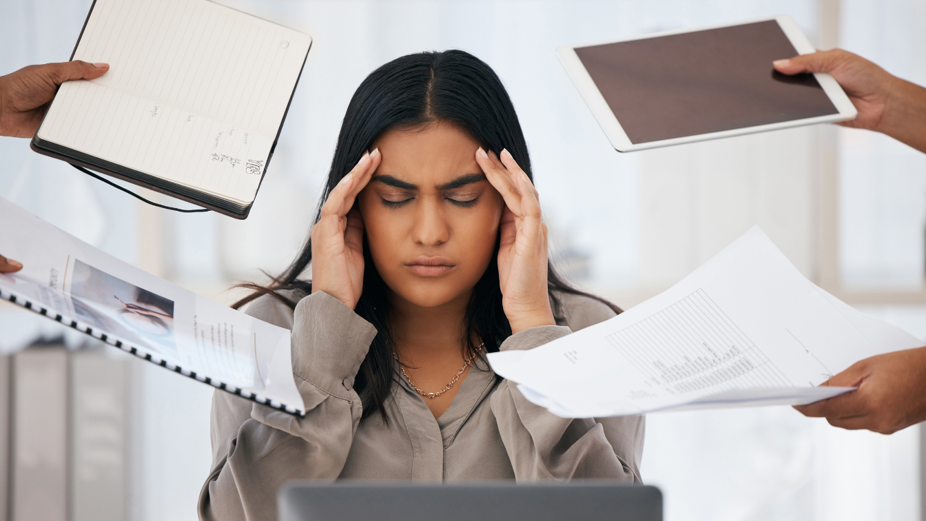 person looking stressed while doing many things at once